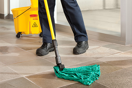 Employee mopping tiled floor